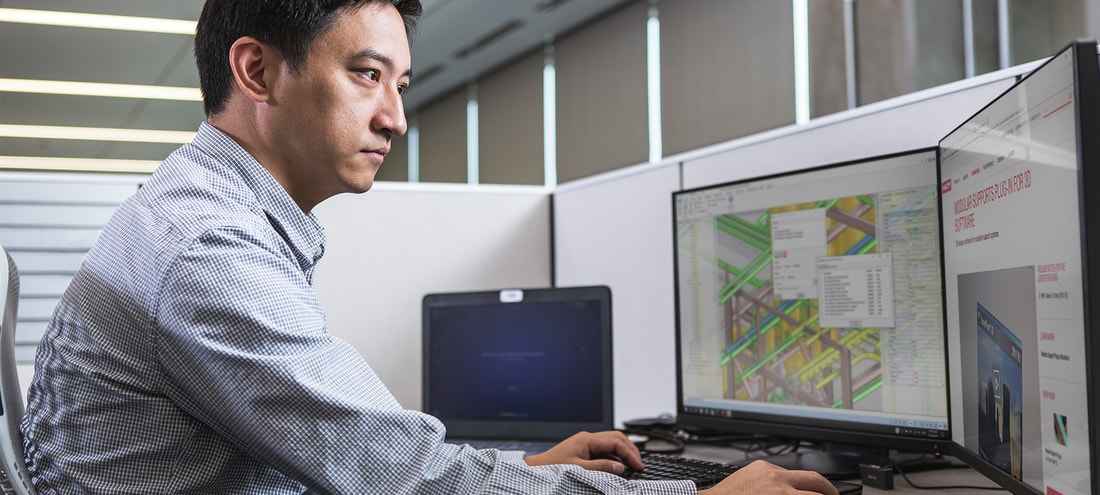 Man at computer using Hilti Modular Supports Plug-In