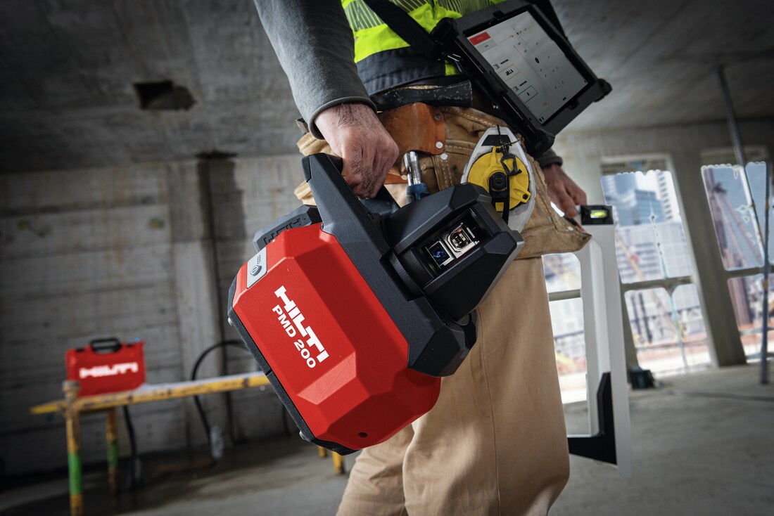 Worker carrying the PMD 200 at a jobsite