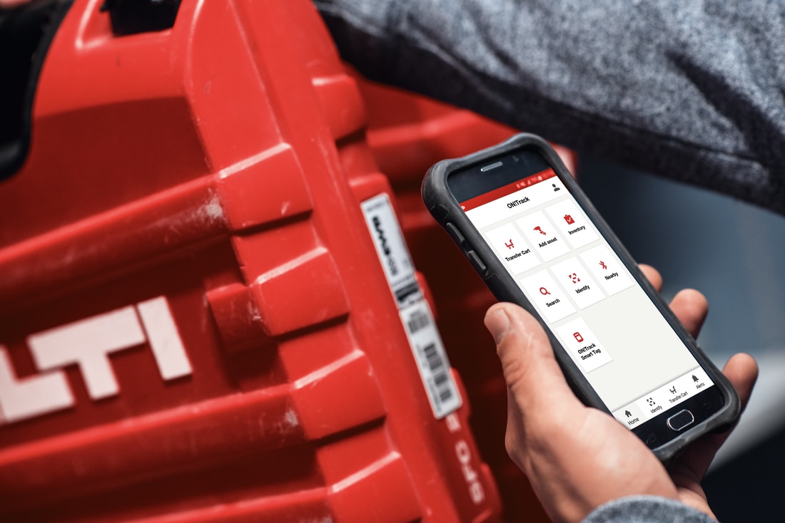 A worker uses ON!Track on a mobile device to scan a Hilti tool box