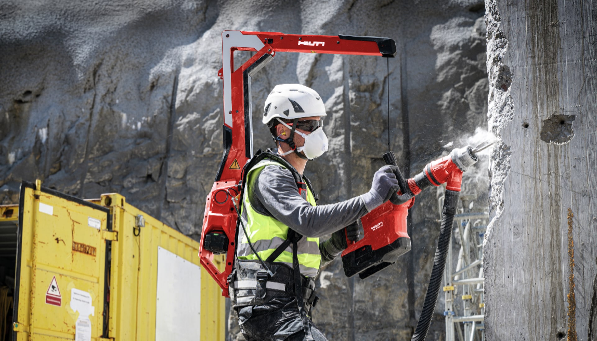 Worker breaking a concrete wall with the help of the EXO-T