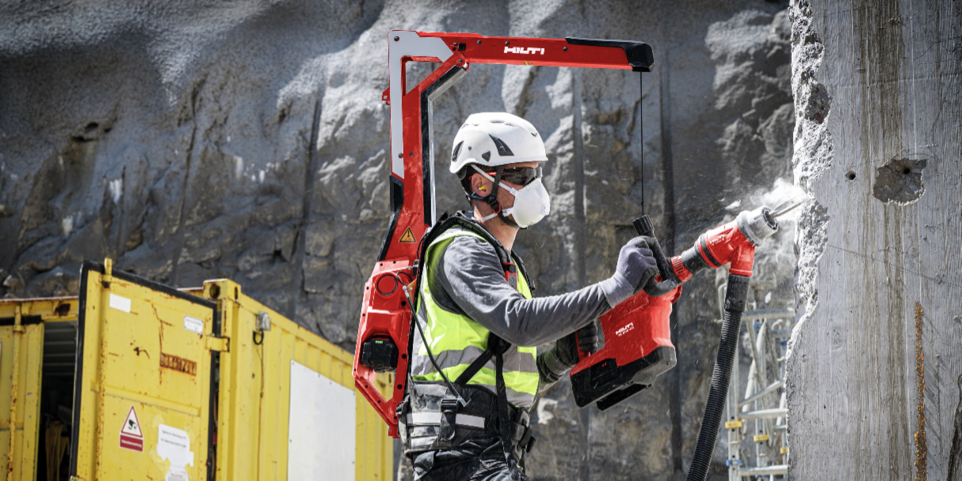 Worker breaks through a concrete wall more easily with help from the EXO T-22 Tool balancer