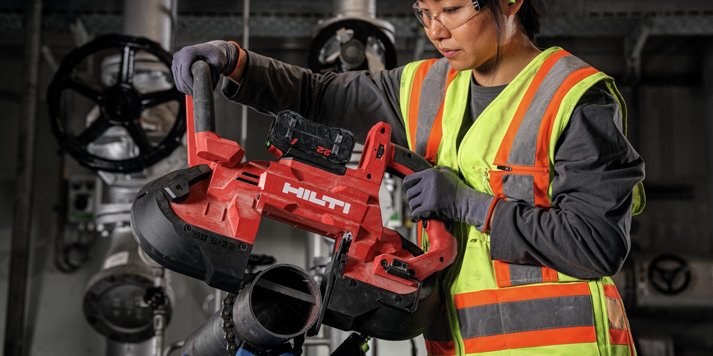 Construction worker using the SB 6-22 to cut through a metal pipe